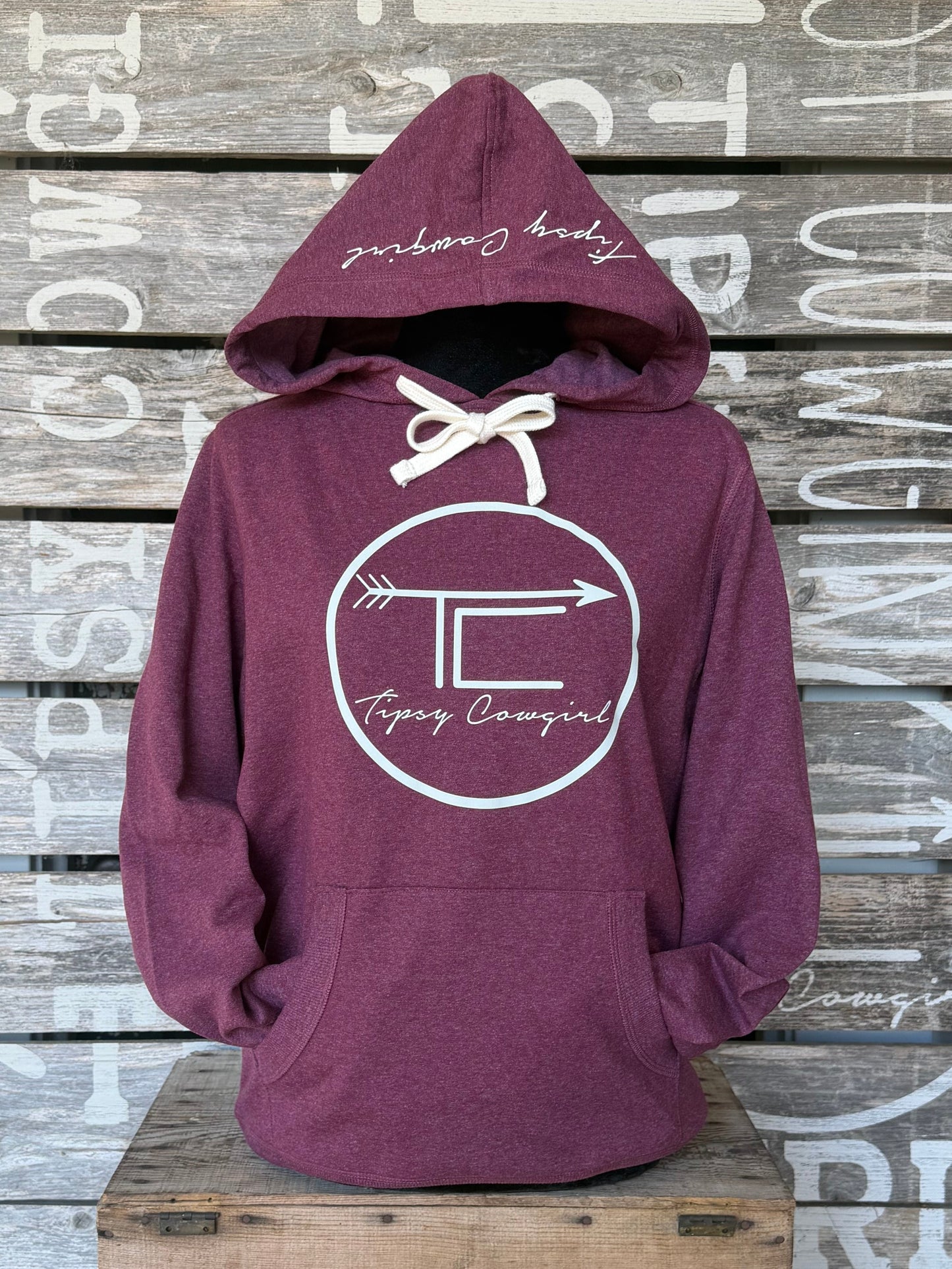 Tipsy Cowgirl Signature heathered maroon Re-Fleece hoodie with white TC arrow graphic and hood detail