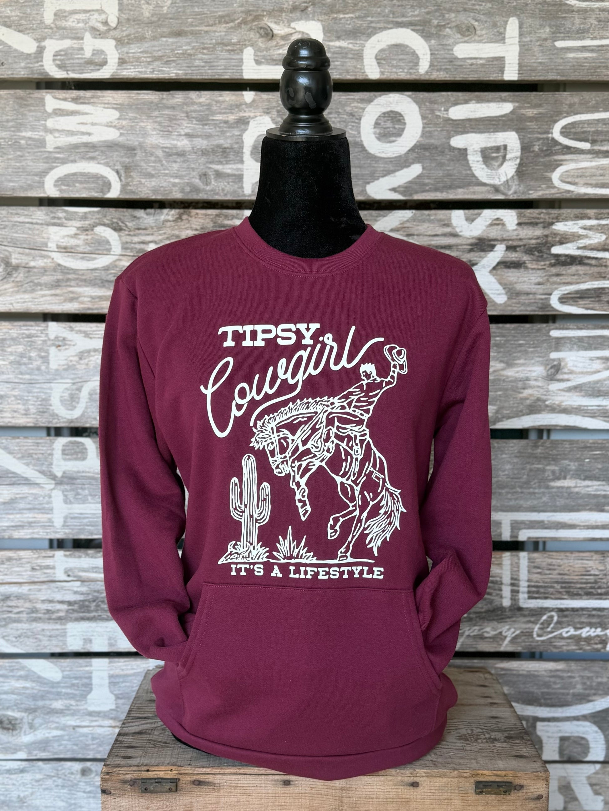 Tipsy Cowgirl Lifestyle maroon pocket crewneck sweatshirt with white bucking bronc western graphic