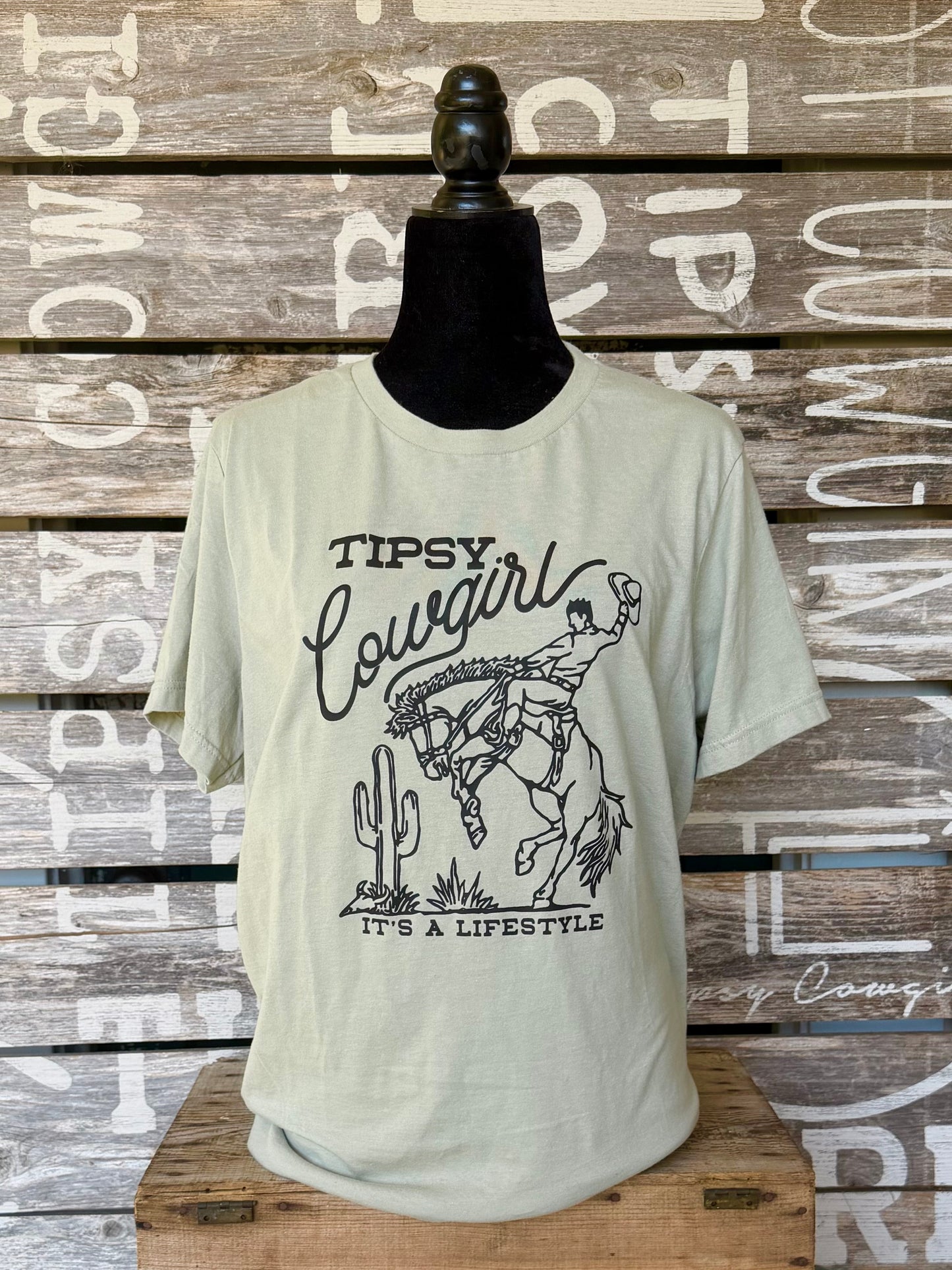 Tipsy Cowgirl Lifestyle Thyme western T-shirt with black bucking bronc graphic