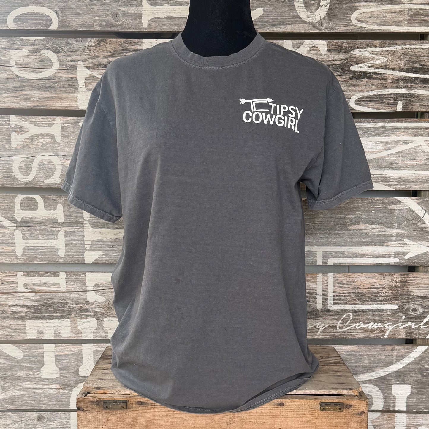 Front of Tipsy Cowgirl Pepper tee featuring small white TC arrow logo on the left chest
