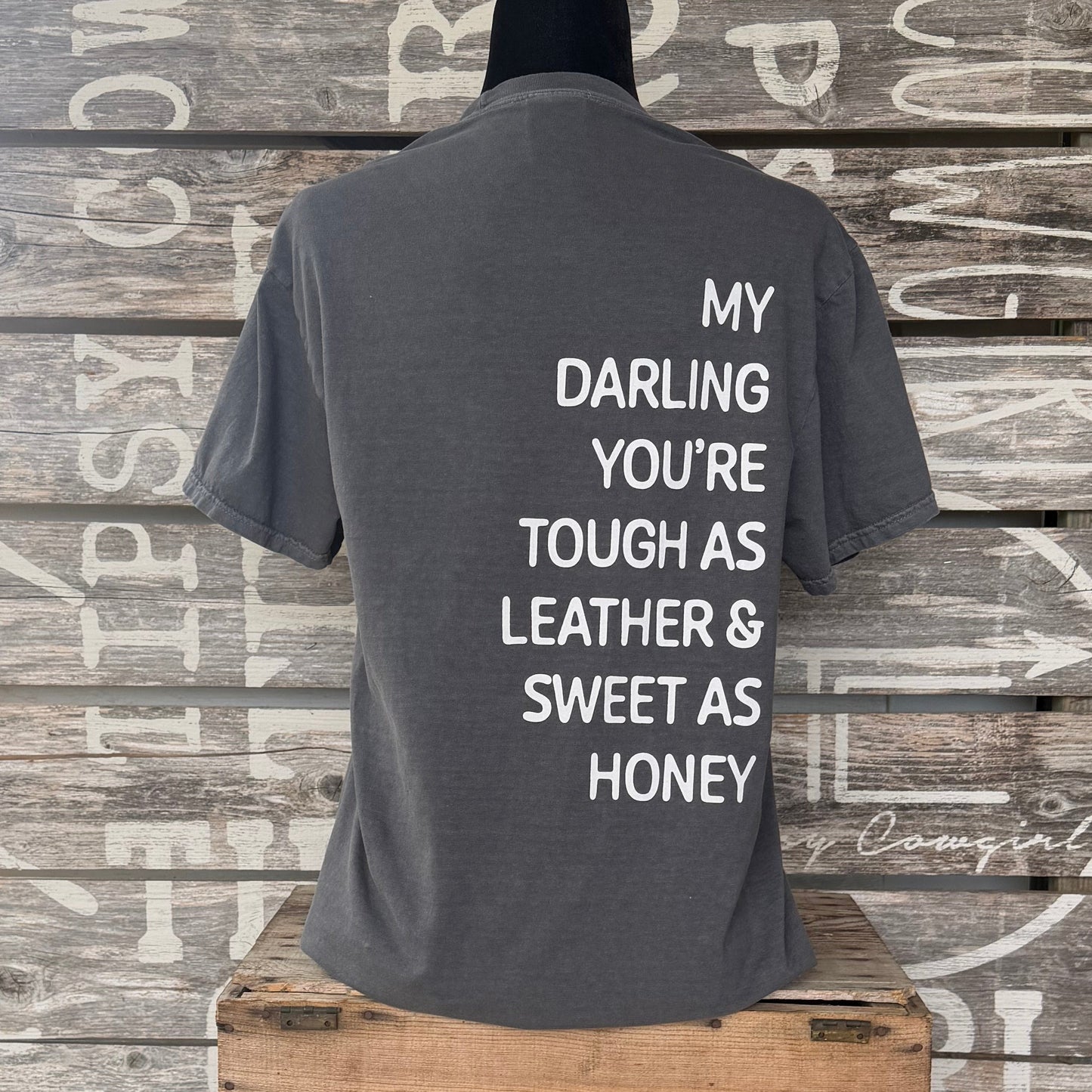 Back of Tipsy Cowgirl Pepper tee featuring white My Darling You're Tough as Leather & Sweet as Honey western quote