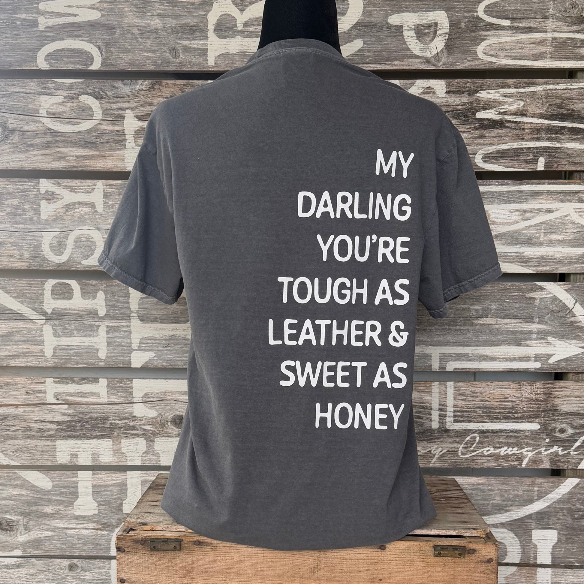 Back of Tipsy Cowgirl Pepper tee featuring white My Darling You're Tough as Leather & Sweet as Honey western quote
