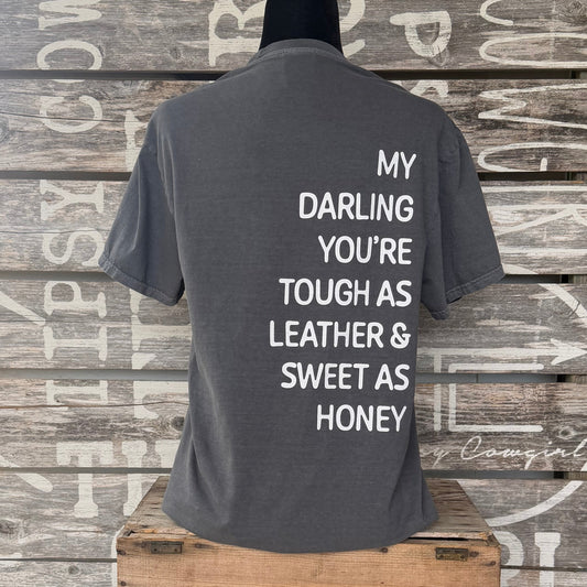 Back of Tipsy Cowgirl Pepper tee featuring white My Darling You're Tough as Leather & Sweet as Honey western quote
