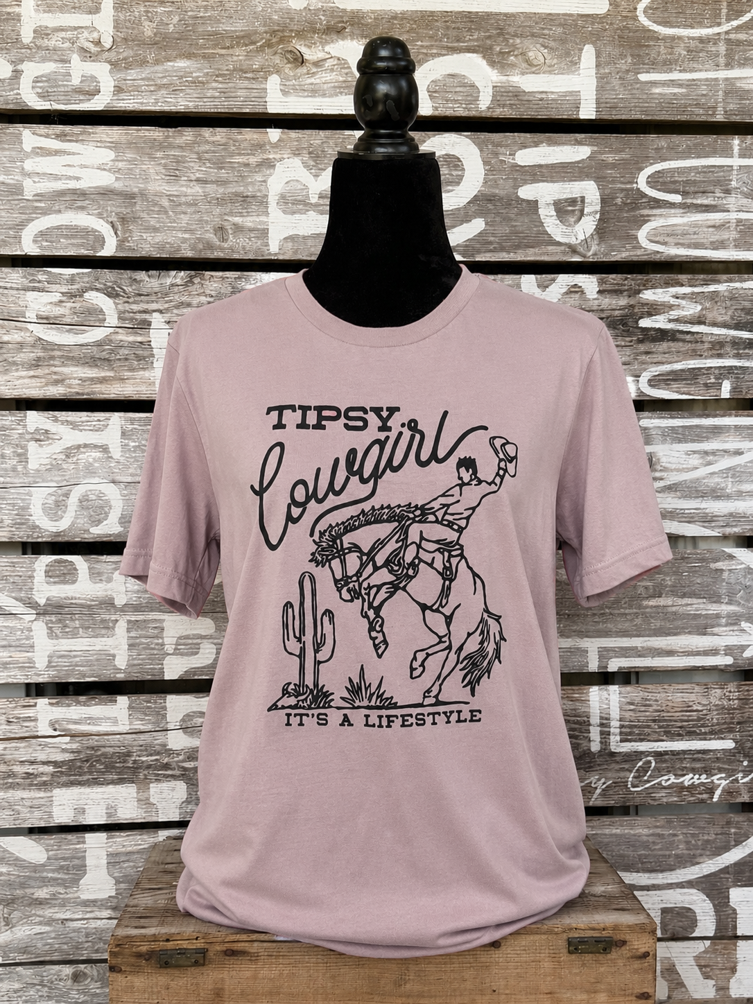 Tipsy Cowgirl Lifestyle Pink Gravel western T-shirt with black bucking bronc graphic